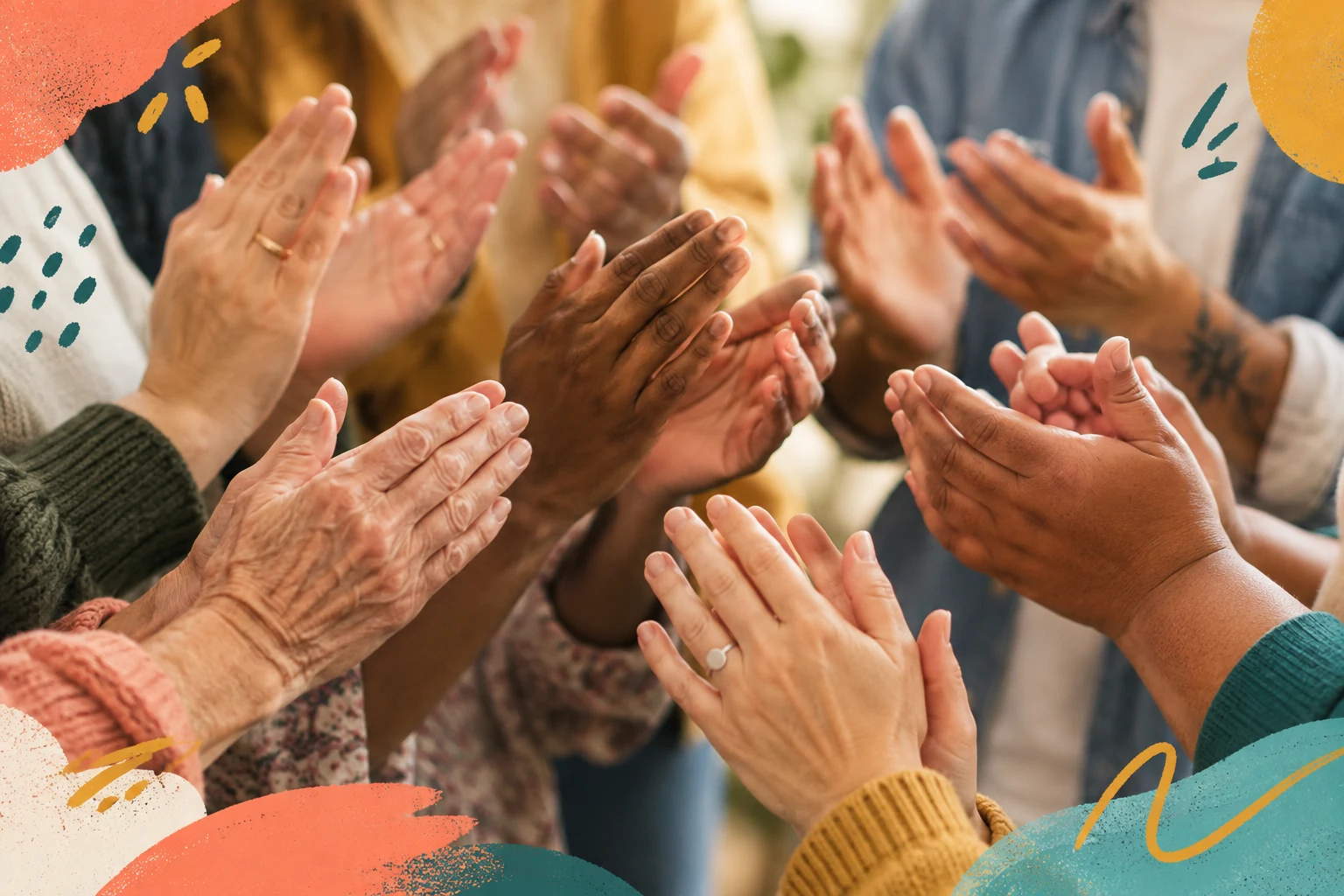 A close-up of hands of different ages and skin tones applauding together.